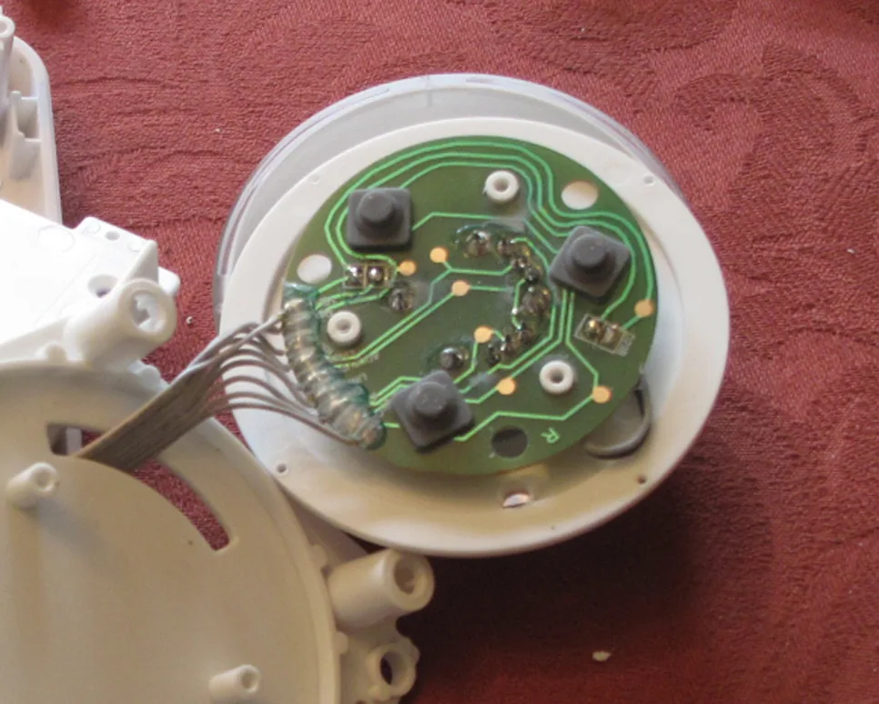 The underside of the button's small PCB, showing the joystick and three momentary switches arranged in a triangle.