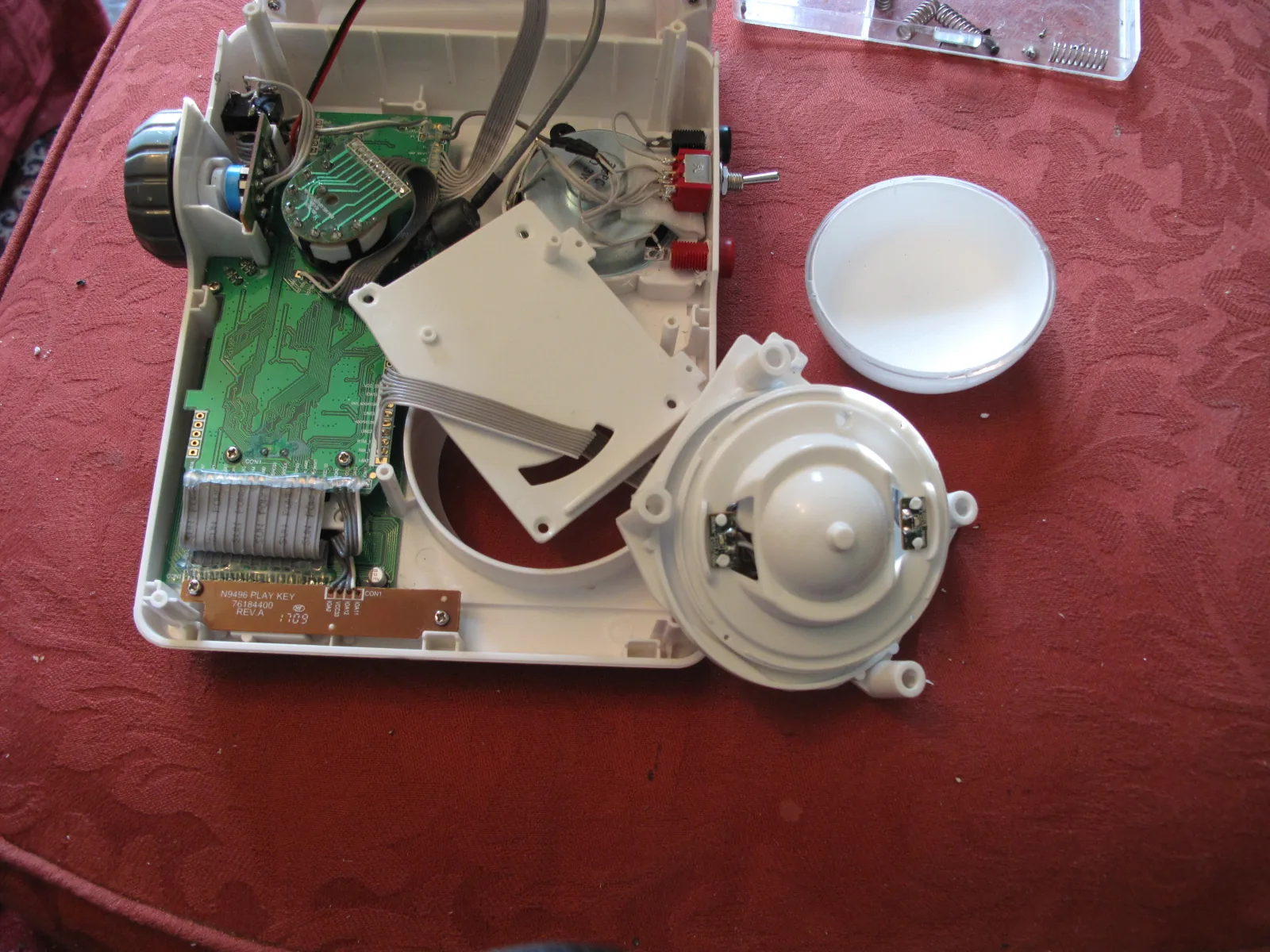 The big control button partially dismantled to reveal the mechanism inside.