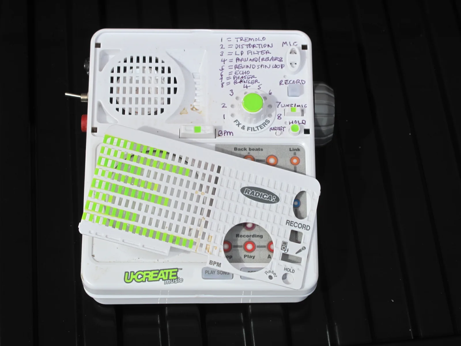 The front grille removed, showing the printed list of the 8 effects and the order they come in.