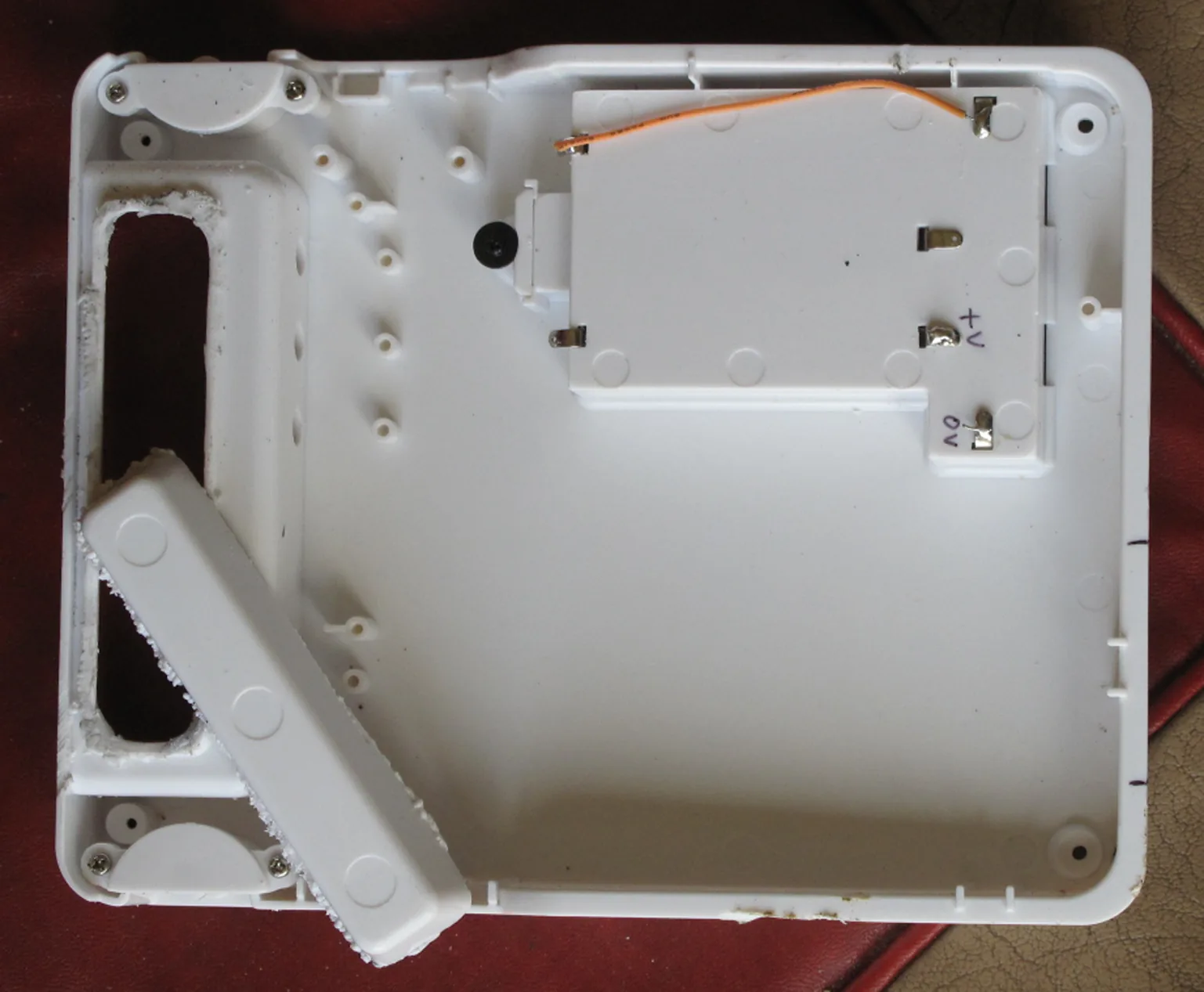 The inside of the case with part of the moulded projection being sawn away to make room for the DB9 sockets.