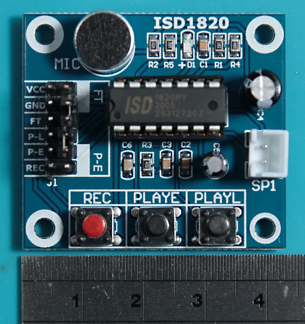 The unmodified ISD1820 voice-recorder board, showing the on-board mic, the Dupont breakout headers down the left side, the ISD1820 chip in the centre, the white audio-out connector on the right, and the function buttons along the bottom.