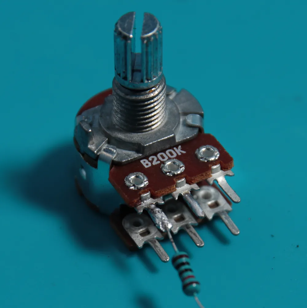 A 10K resistor soldered - roughly - to the left leg of a 200K stereo potentiometer.
