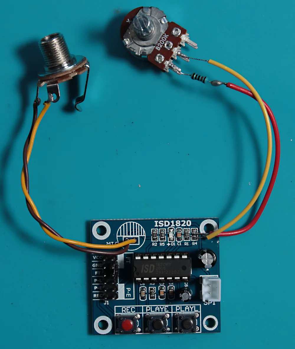 The modified board with a 1/4-inch socket wired in for the mic input and the resistor-and-pot combo wired in for pitch control.