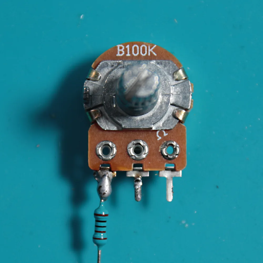 The delay-time potentiometer with a 1K resistor soldered to its left leg.