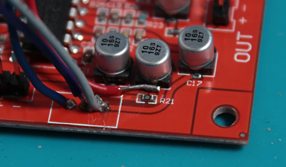 The feedback wire soldered onto capacitor C15.