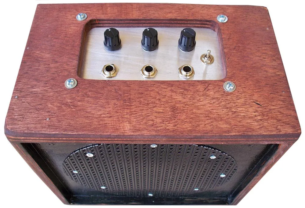 The finished MFOS mini mixer and amplifier in a small plywood box, seen from the top with three level knobs and a power switch.