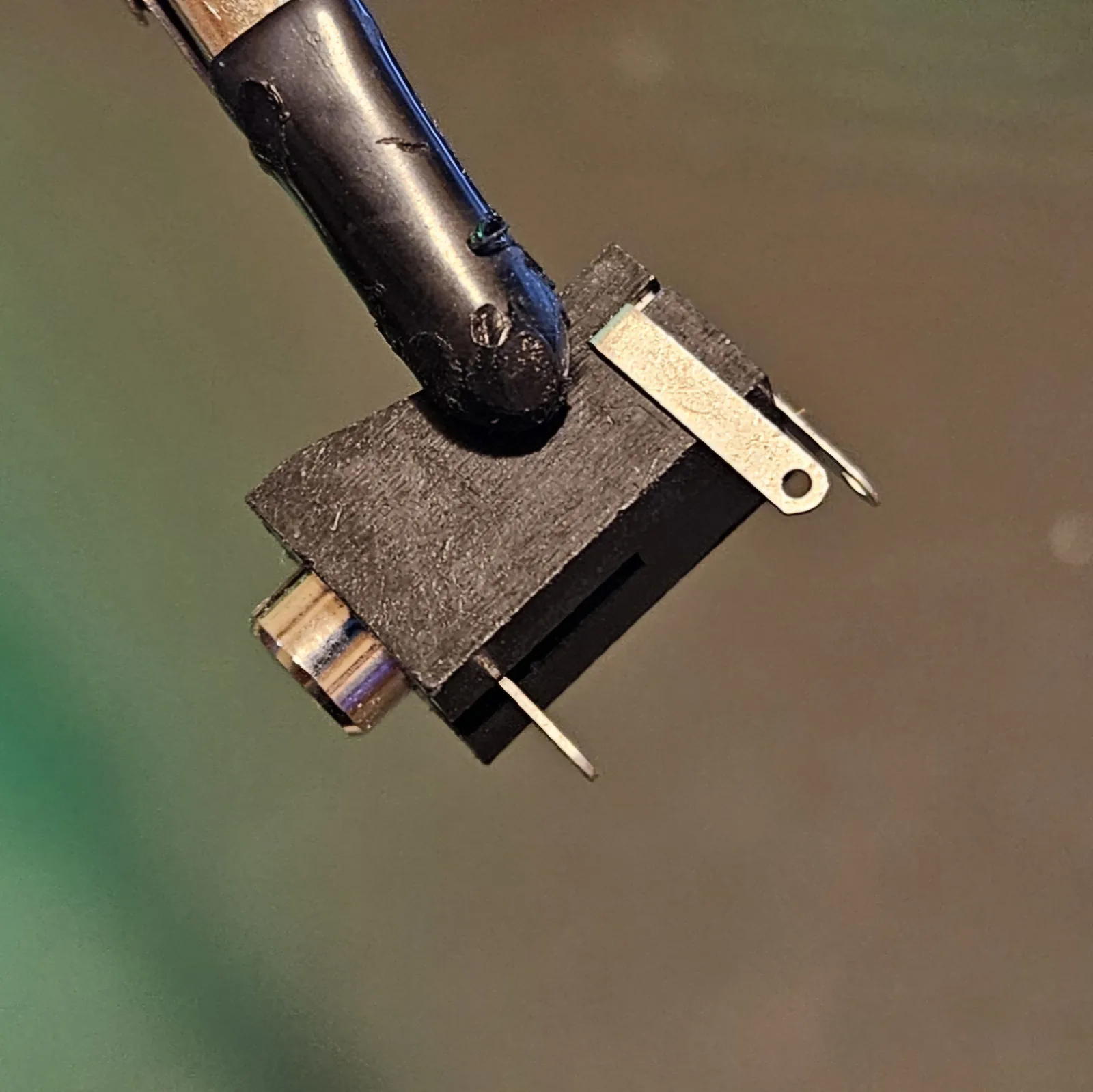 A panel-mount output jack with its solder lugs.
