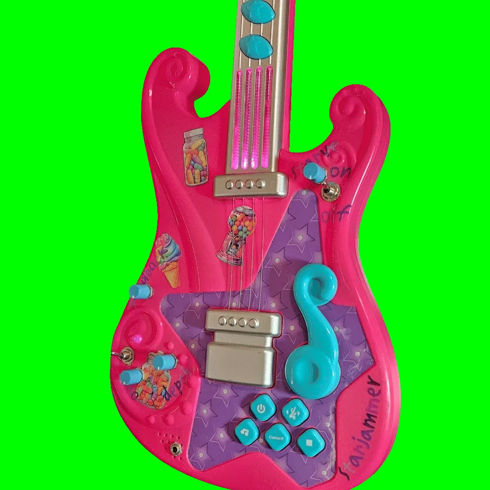 The same guitar in a dim room with the lights running: the four clear plastic string strips on the neck glow hot magenta-pink from end to end, and a smaller pink glow shows inside the moulded swirl at the lower left of the body. The added knobs, toggles and marker labels stay visible in the low light.