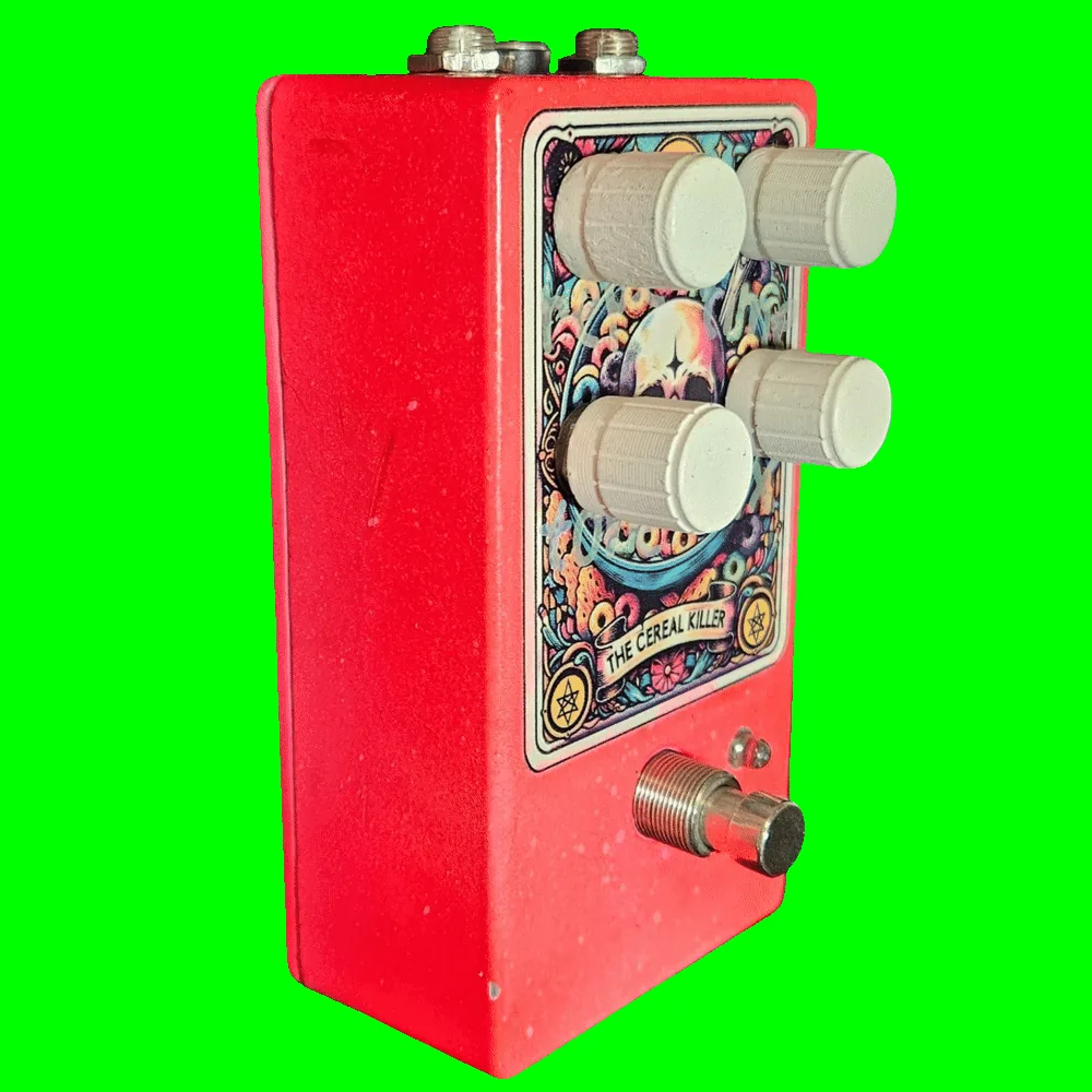 Left side of the pedal: a plain red wall with a few light scuffs, showing the depth of the enclosure and the profile of the four cream knobs standing off the face. The footswitch and a small clear LED sit low on the front.