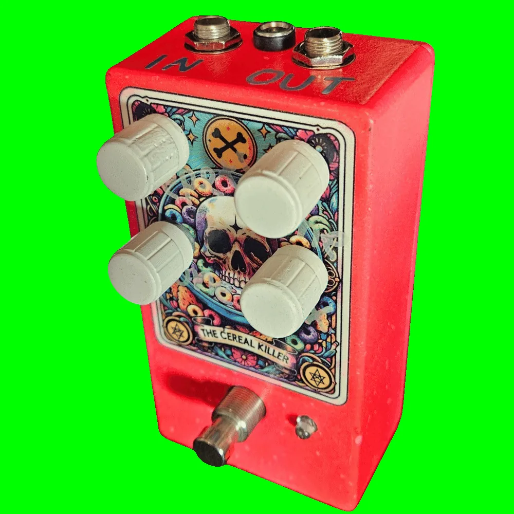 Top-down view of the enclosure: the top edge is stencilled "IN" above the left 1/4-inch jack and "OUT" above the right, with a DC power jack centred between them. The four ribbed cream knobs sit in two rows of two over the tarot card; they carry no printed labels on the enclosure, and are Time, Repeats, Mix and Tone.