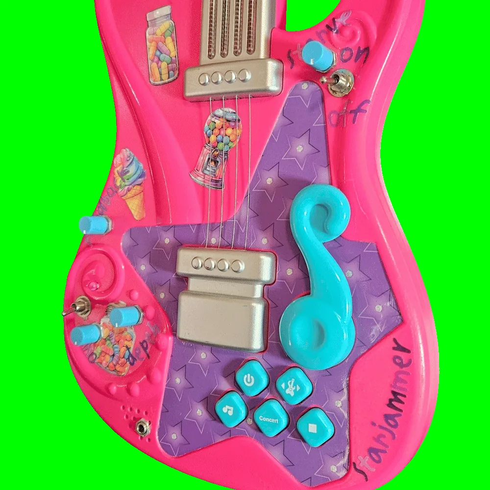 Close-up of the lower body: four small turquoise knobs and two chrome toggle switches added into the hot-pink shell around the original silver pickups, the turquoise treble-clef whammy bar and the factory buttons marked with a power symbol, a music note and "Concert". Handwritten purple marker labels read "starve", "on" and "off" beside the upper toggle and "depth" beside two of the knobs; a silver quarter-inch jack is mounted at the bottom edge next to the speaker slots, and "starjammer" is written in purple marker along the lower right curve. Candy stickers &mdash; a jar of sweets, a gumball machine, an ice cream cone and a heart-shaped candy jar &mdash; are stuck across the pink areas.
