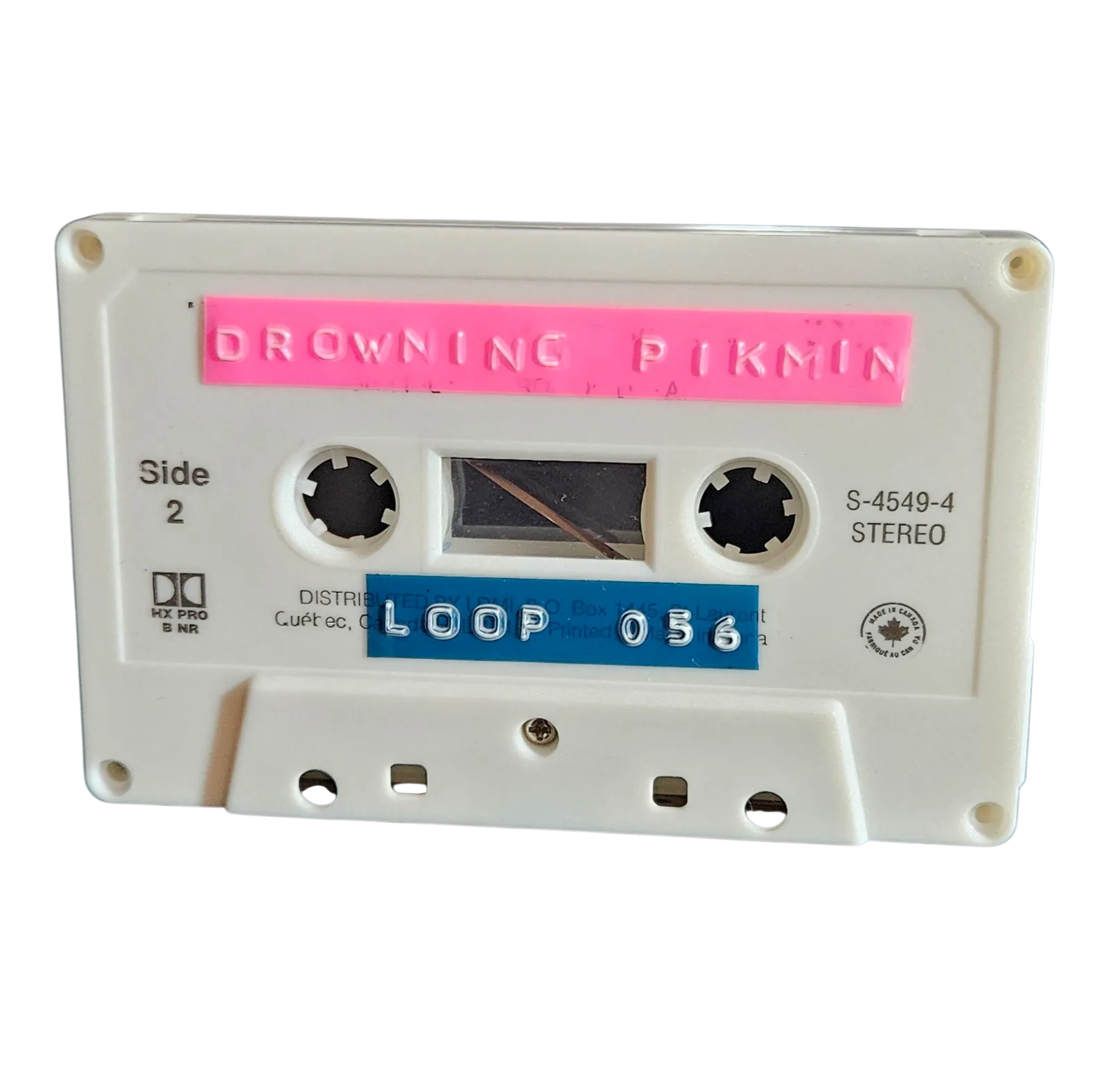 White cassette shell with a pink hand-lettered Drowning Pikmin label and a blue Loop 056 strip