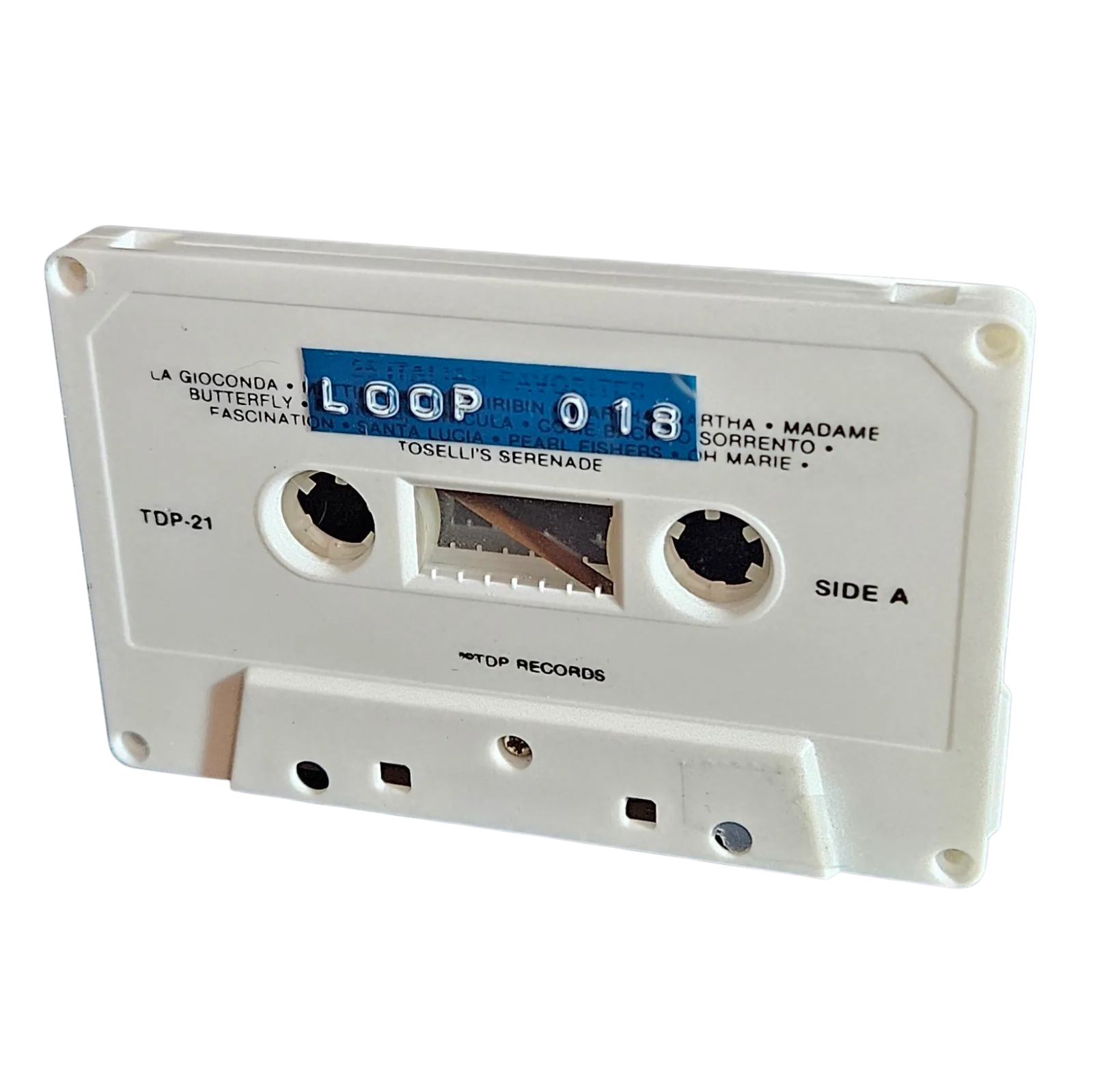 White cassette shell labeled Loop 018 on a blue strip, originally a tape of Italian favorites with the printed tracklist showing through