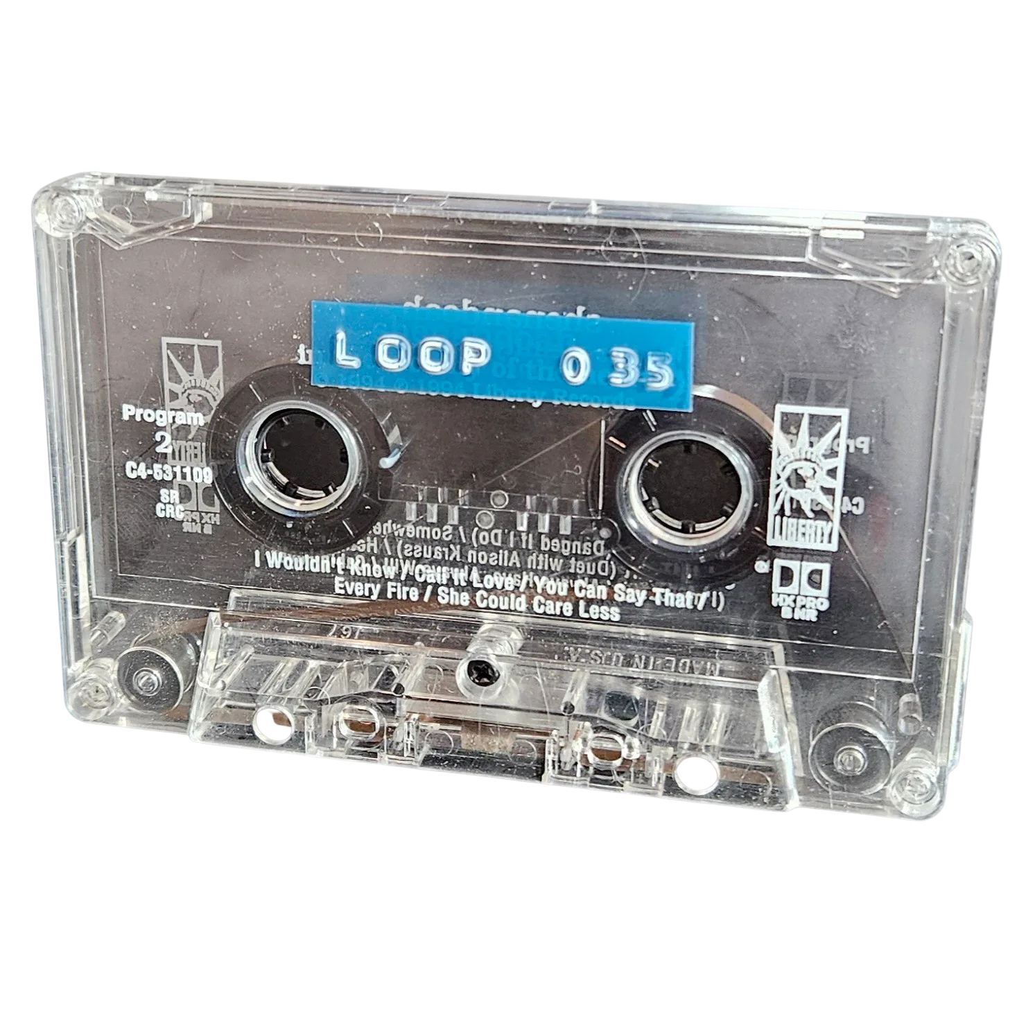 Clear cassette shell labeled Loop 035 on a blue strip, recycled from a Liberty Records country compilation