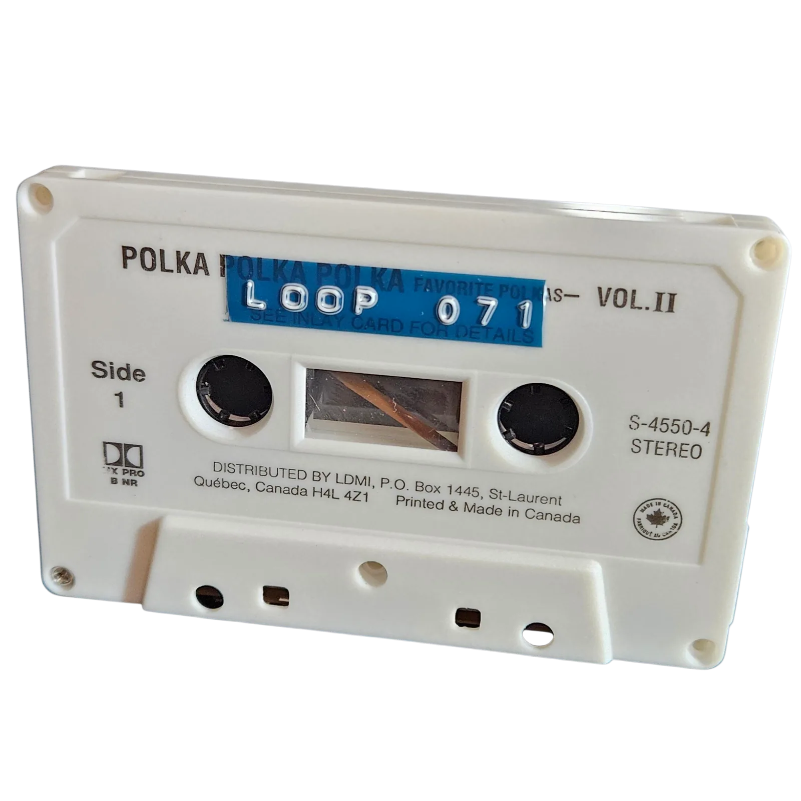 White cassette shell labeled Loop 071 on a blue strip, recycled from a Polka Polka Polka Vol. II cassette made in Canada