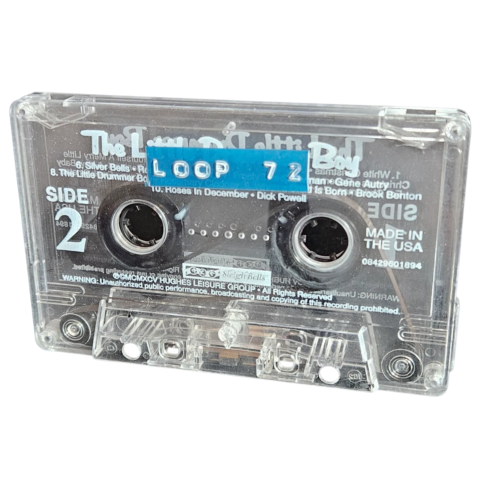 Clear cassette shell labeled Loop 72 on a blue strip, recycled from a Little Drummer Boy Christmas compilation